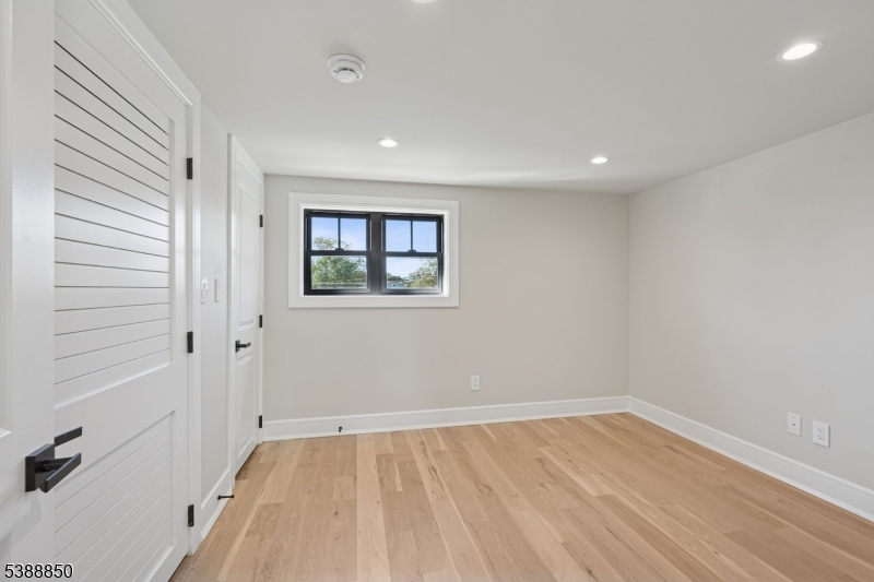 27 Willow Street, Unit A Millburn, NJ 07041 - Photo 41 of 50 wooden floor in an empty room with a window