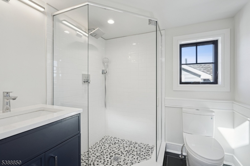 27 Willow Street, Unit A Millburn, NJ 07041 - Photo 42 of 50 a bathroom with a sink a toilet and shower