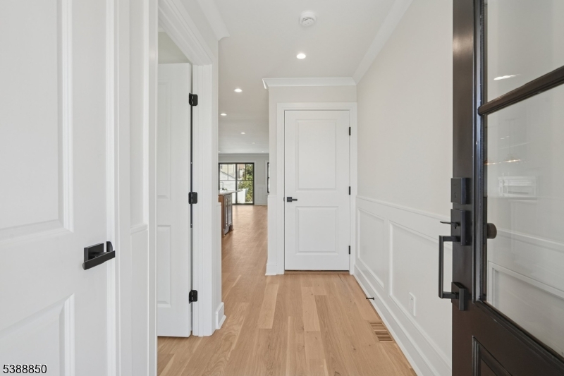 27 Willow Street, Unit A Millburn, NJ 07041 - Photo 6 of 50 a view of a hallway with wooden floor and staircase