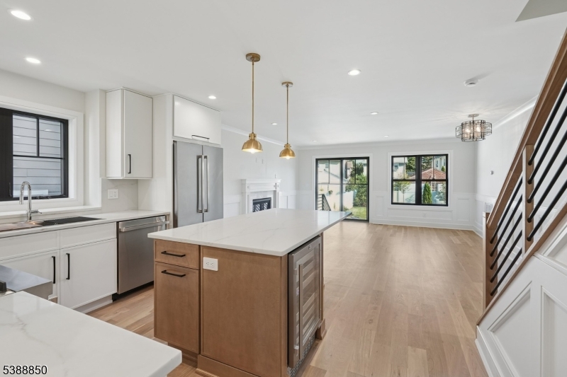 27 Willow Street, Unit A Millburn, NJ 07041 - Photo 9 of 50 a large kitchen with kitchen island a stove a sink a refrigerator and a dining table