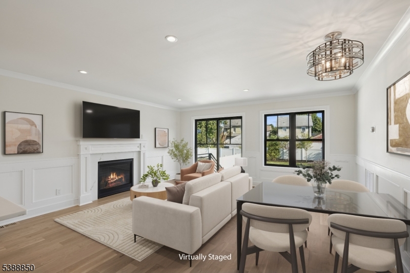 27 Willow Street, Unit A Millburn, NJ 07041 - Photo 10 of 50 a living room with furniture a fireplace and a flat screen tv