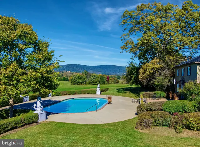a living room with a furniture and a fireplace