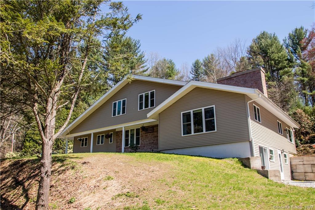 515 Litchfield Road Harwinton, CT 06791 - Photo 1 of 1 a house with trees in the background