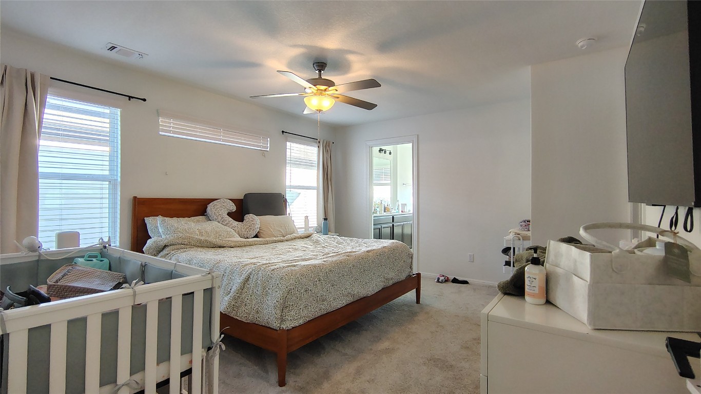 316 Turnbuckle Bend Leander, TX 78641 - Photo 11 of 21 a bedroom with a bed and ceiling fan