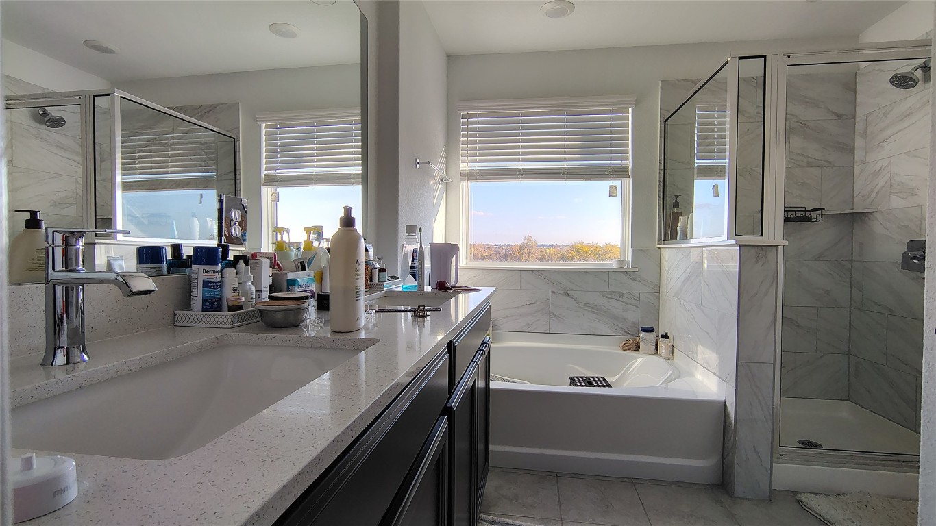 316 Turnbuckle Bend Leander, TX 78641 - Photo 12 of 21 a bathroom with a bathtub and a sink