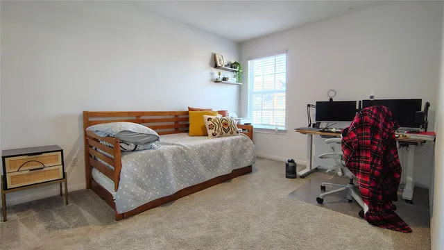 a bedroom with bed and a window