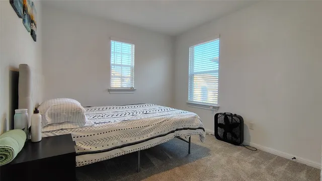 a bedroom with bed and a window