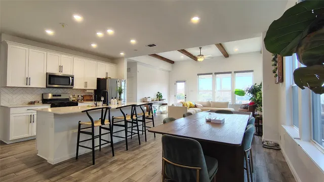 a view of kitchen with cabinets table and chairs