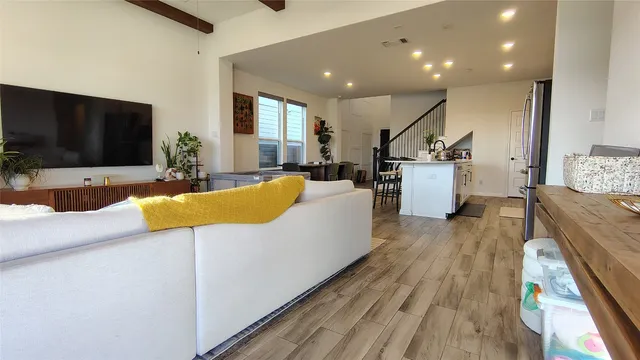 a living room with furniture pool table and a flat screen tv