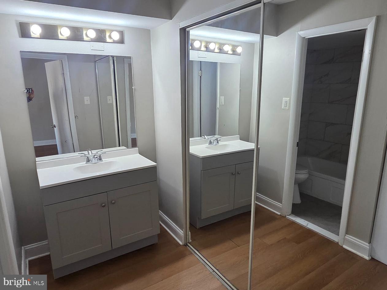 1440 N Street Northwest, Unit 1011 Washington, DC 20005 - Photo 5 of 14 a bathroom with a double vanity sink and mirror