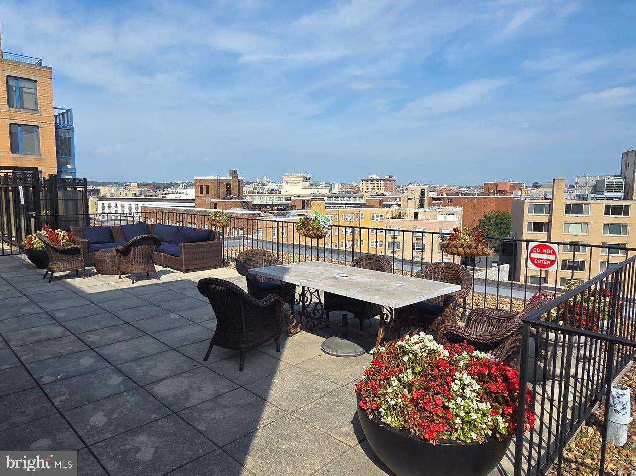 1440 N Street Northwest, Unit 1011 Washington, DC 20005 - Photo 9 of 14 a terrace with outdoor seating and city view