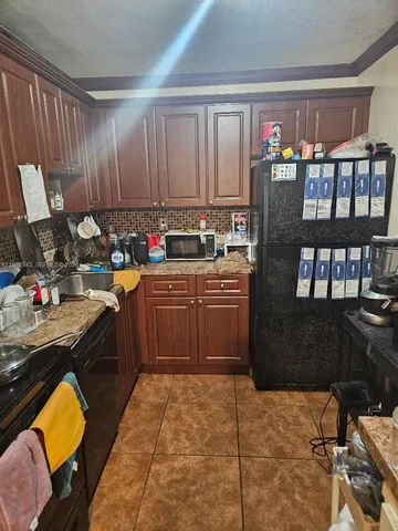 a kitchen with a sink appliances and cabinets