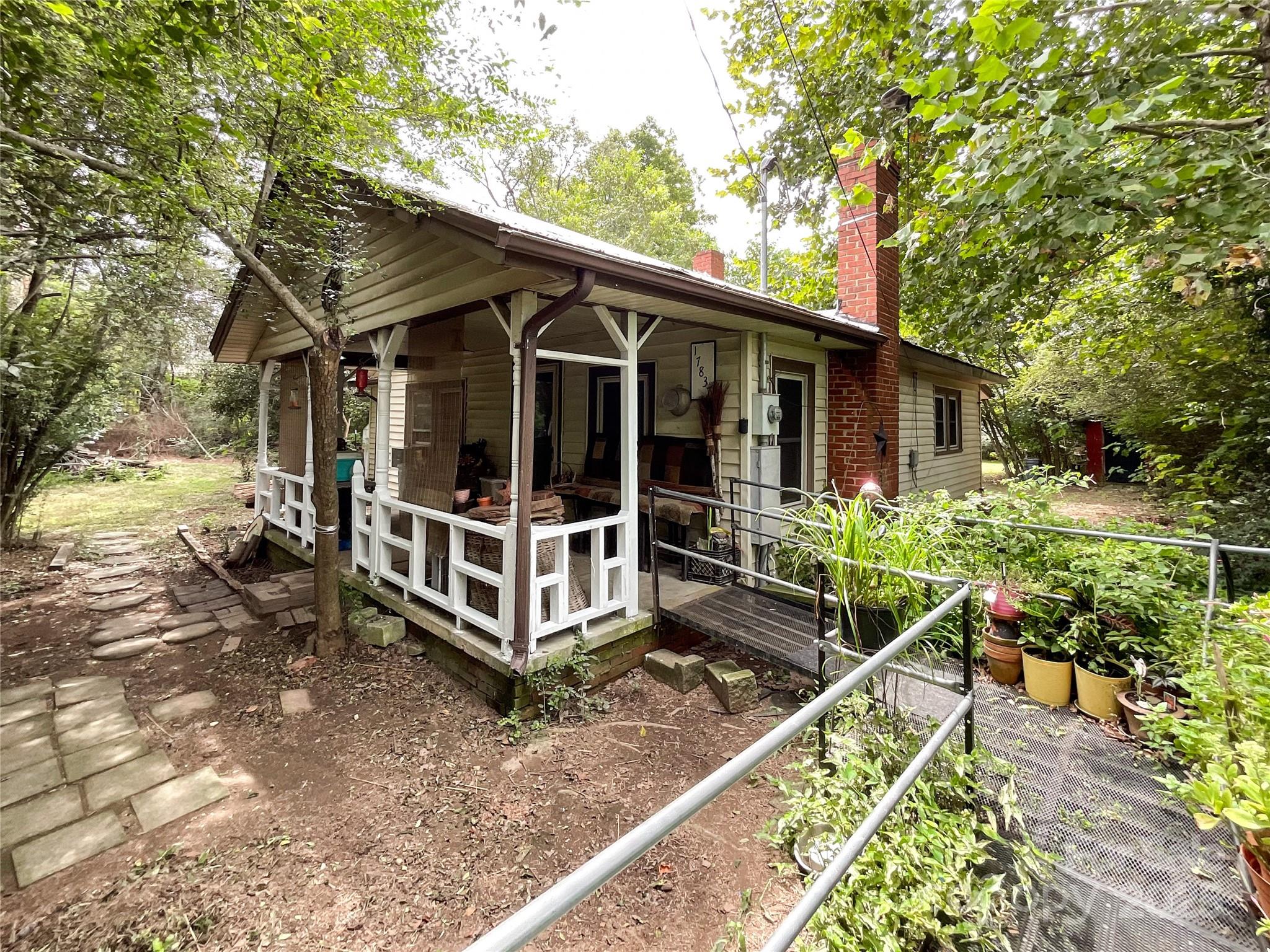 17837 Porter Hill Road Norwood, NC 28128 - Photo 16 of 37 a view of a house with backyard sitting area and garden