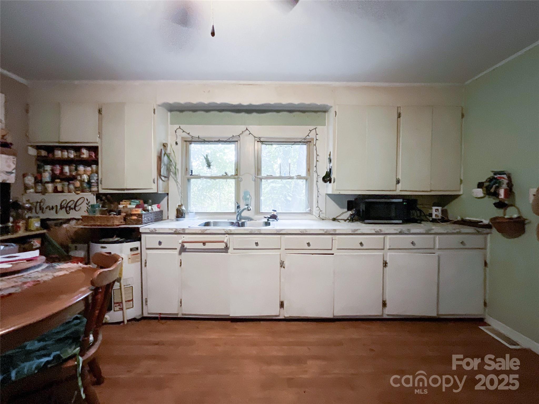17837 Porter Hill Road Norwood, NC 28128 - Photo 19 of 37 a kitchen with a sink cabinets and window