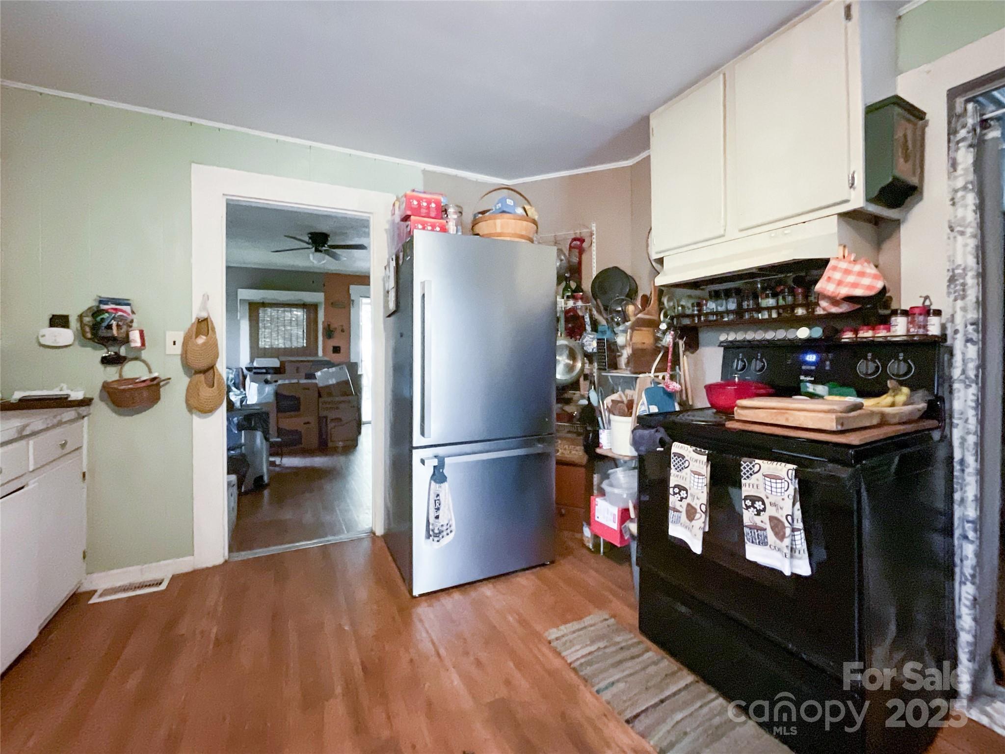 17837 Porter Hill Road Norwood, NC 28128 - Photo 20 of 37 a kitchen with a refrigerator and a stove top oven
