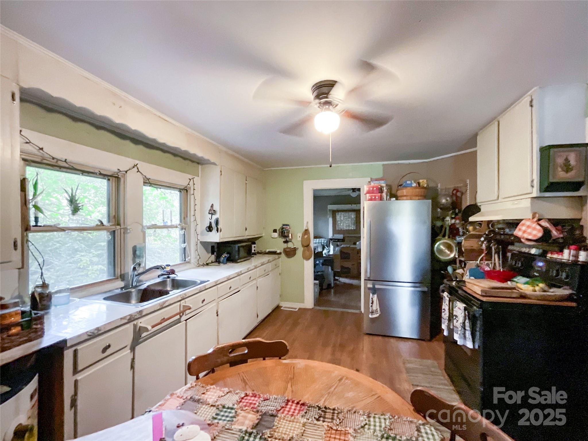 17837 Porter Hill Road Norwood, NC 28128 - Photo 22 of 37 a kitchen with stainless steel appliances kitchen island granite countertop a refrigerator stove top oven and sink