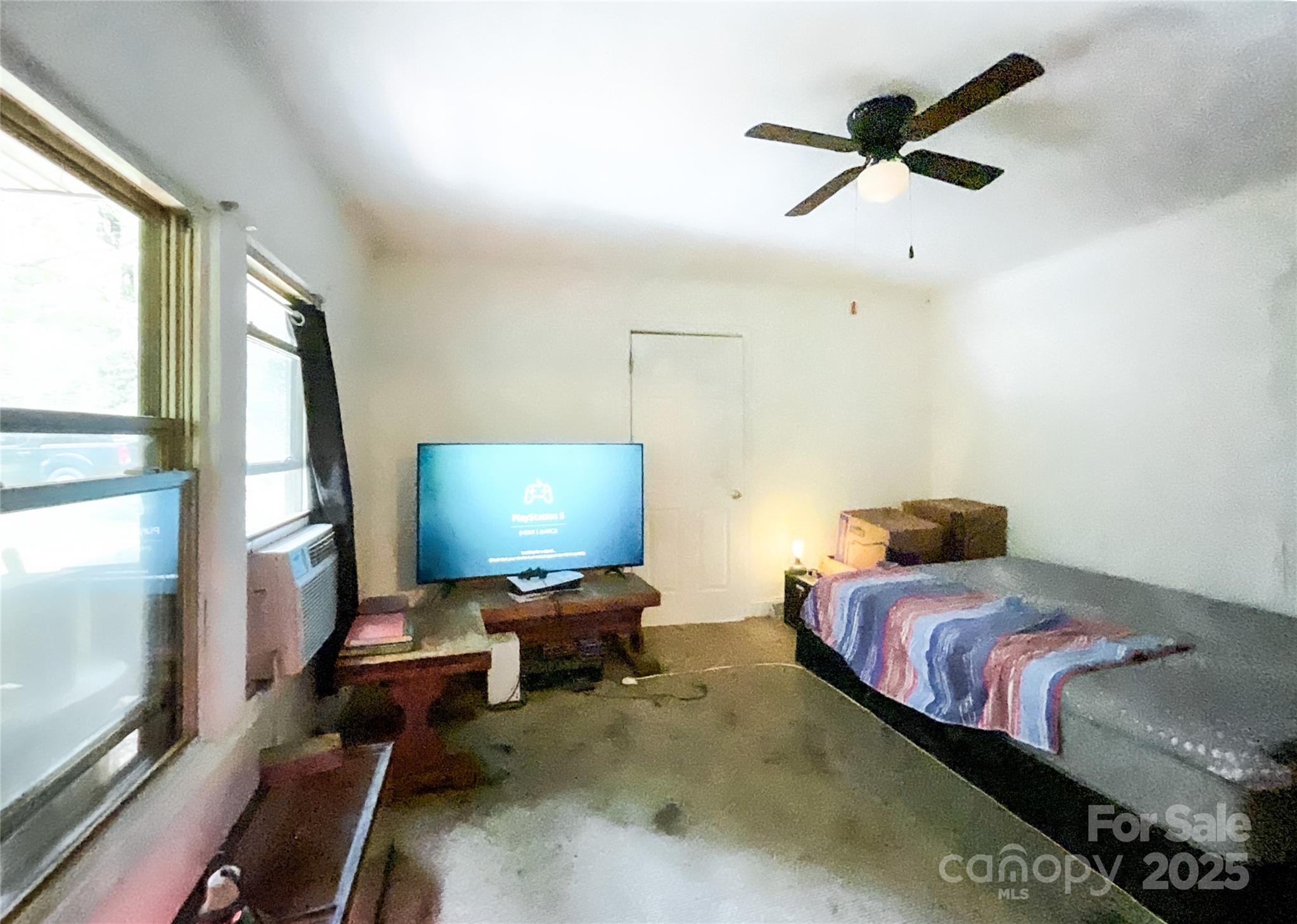 17837 Porter Hill Road Norwood, NC 28128 - Photo 24 of 37 a bedroom with a bed window and a flat screen tv