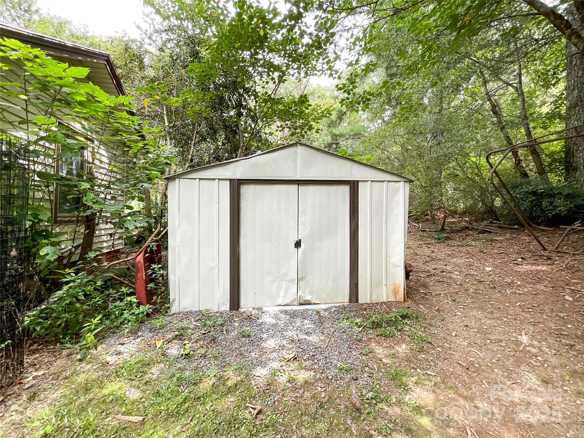 17837 Porter Hill Road Norwood, NC 28128 - Photo 5 of 37 a backyard of a house with large trees and wooden fence