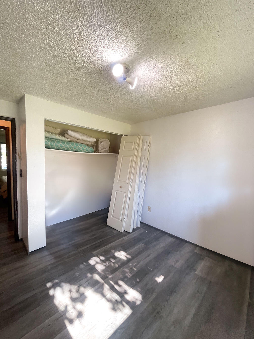 3037 Clearbrook Place Malin, OR 97632 - Photo 21 of 30 an empty room with wooden floor and windows