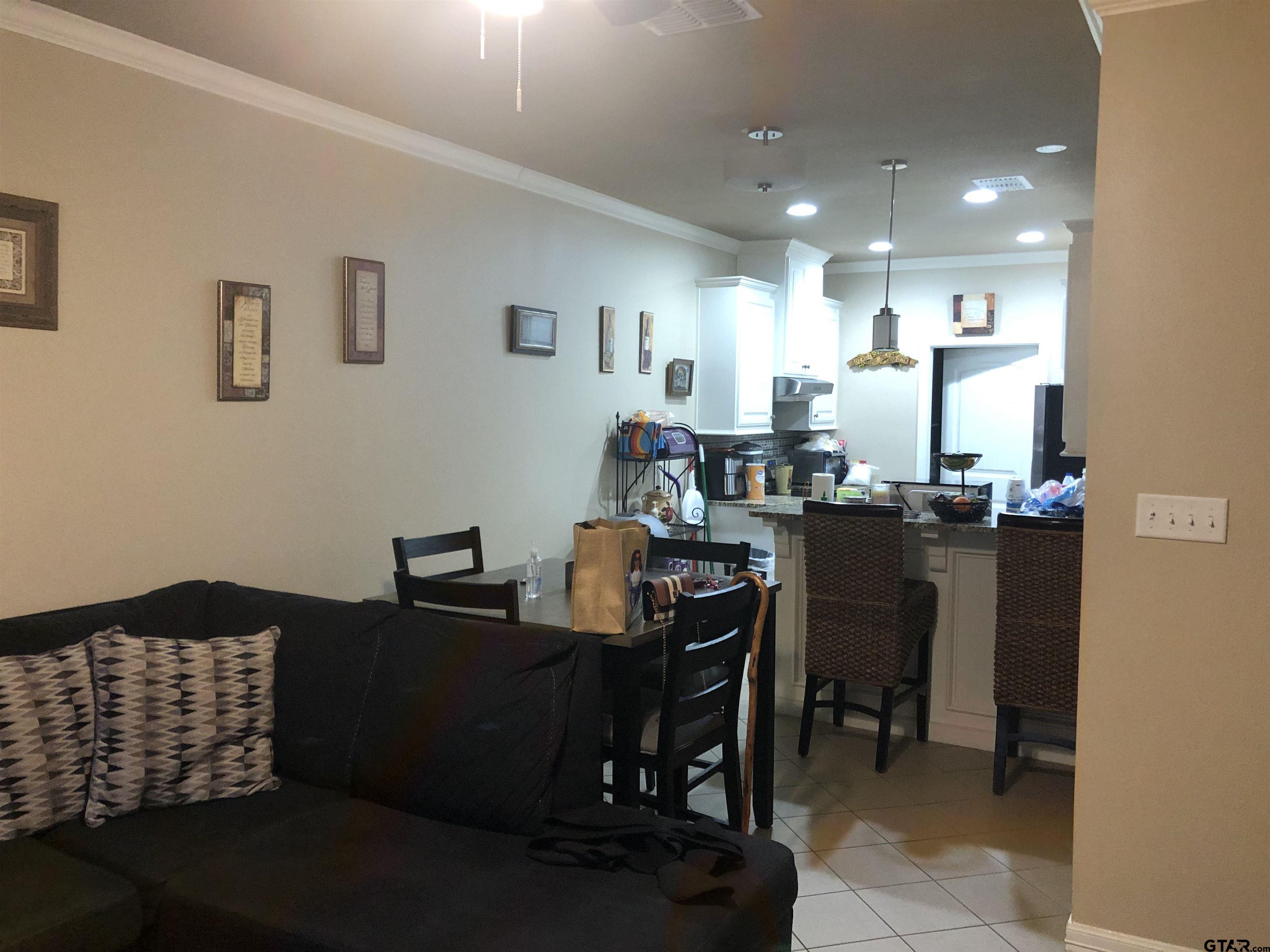 223 South Fenton Avenue Tyler, TX 75702 - Photo 2 of 9 a dining room with furniture and kitchen view