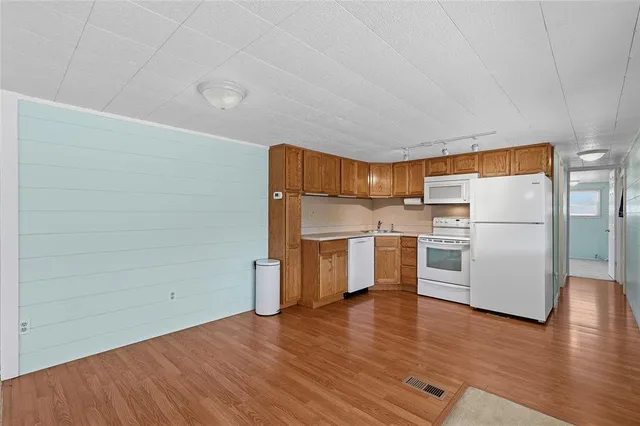 a walk in closet with wooden floor