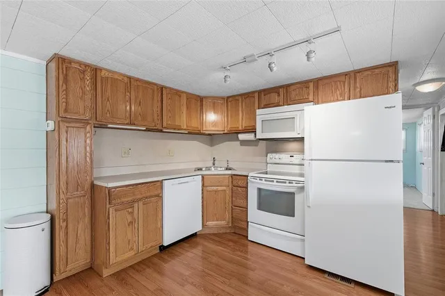 a kitchen with stainless steel appliances a refrigerator sink and cabinets