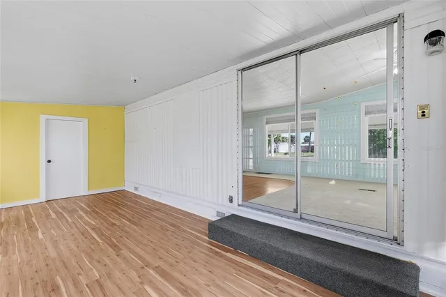 a view of an empty room with glass door