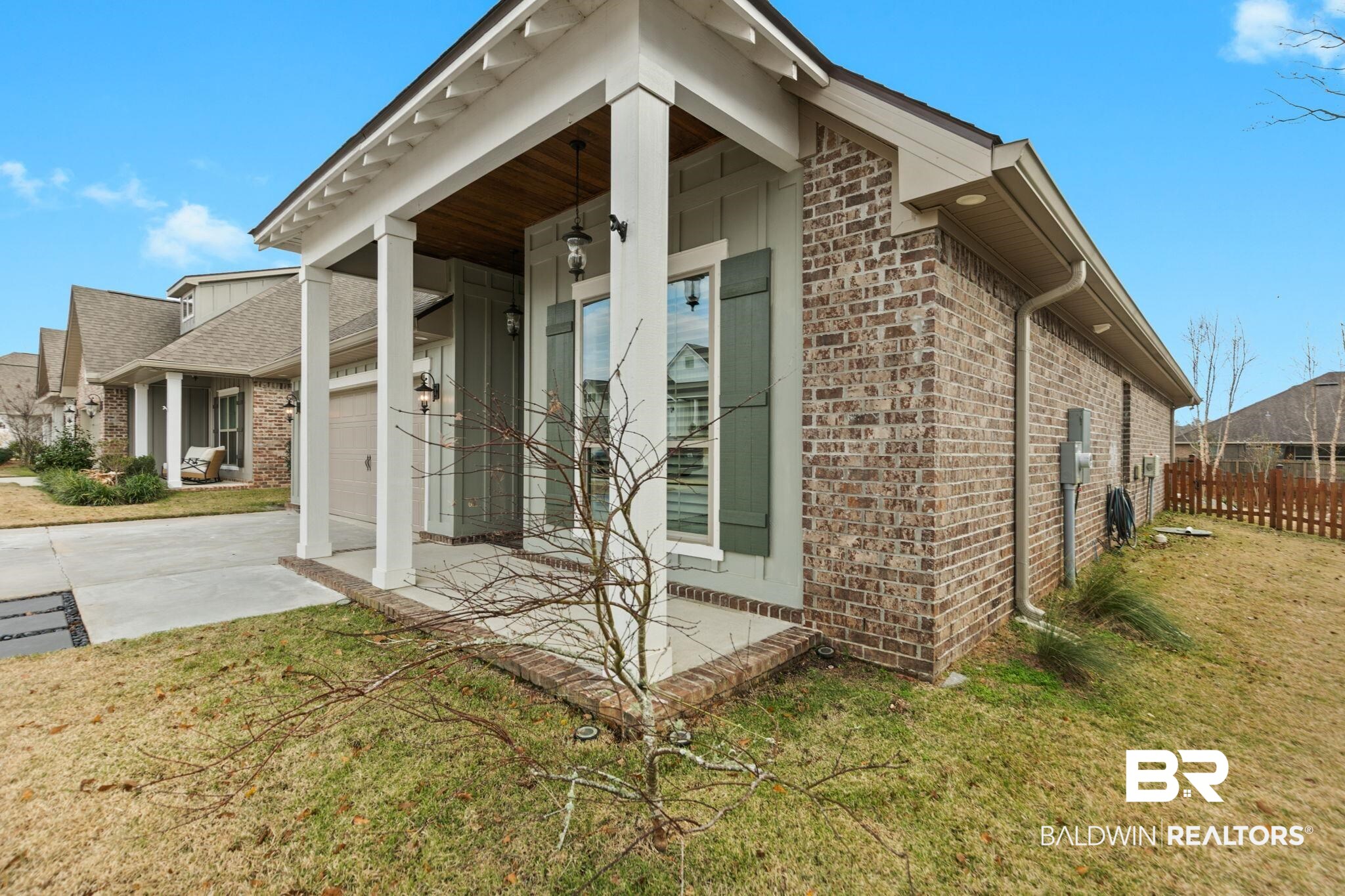 31654 Canopy Loop Daphne, AL 36527 - Photo 48 of 64 View of property exterior with brick siding, driveway, a garage, and covered porch