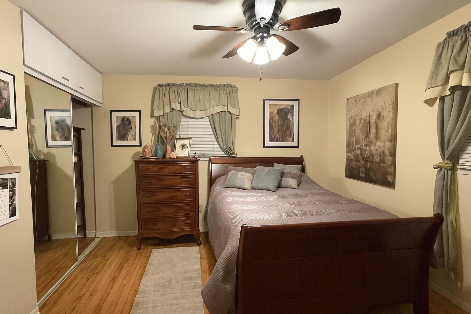 1140 Clinton Street Gary, IN 46406 - Photo 4 of 8 a bedroom with a bed and a chandelier