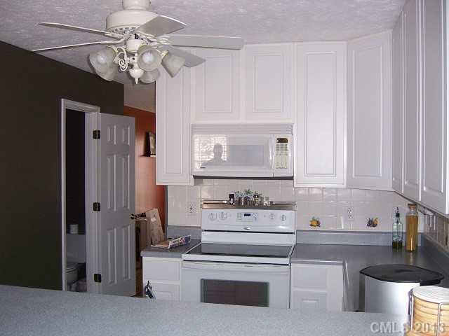 646 Mereva Road Smyrna, SC 29743 - Photo 8 of 15 a kitchen with stainless steel appliances a white stove top oven and cabinets