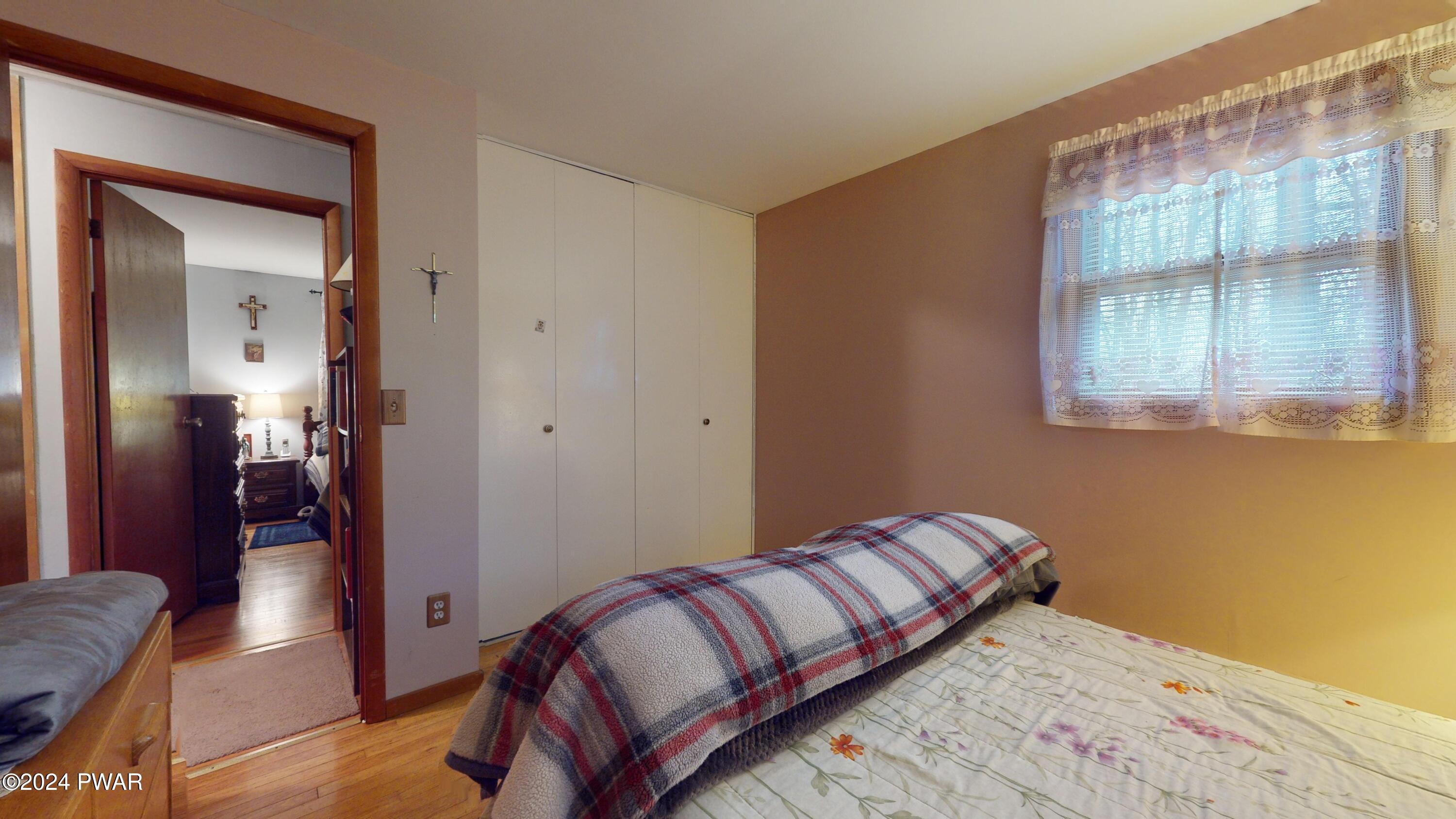 134 Sunnylands Road Milford, PA 18337 - Photo 59 of 59 a bedroom with a bed and a mirror