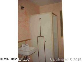 80 Creekside Loop Road Waynesville, NC 28786 - Photo 5 of 9 a bathroom with a sink and a mirror