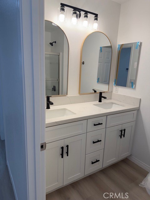 16925 Nanticoke Road Apple Valley, CA 92307 - Photo 13 of 87 a bathroom with a double vanity sink and mirror
