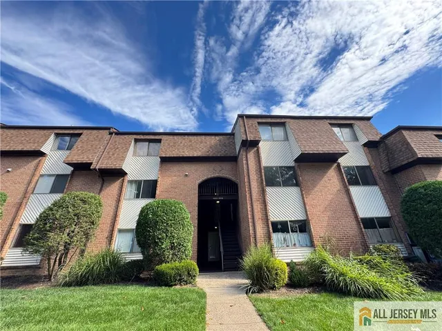a front view of a house with plants