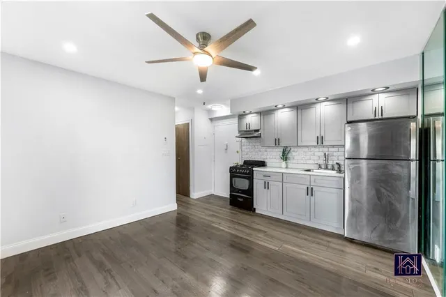 a kitchen with stainless steel appliances a refrigerator sink and stove