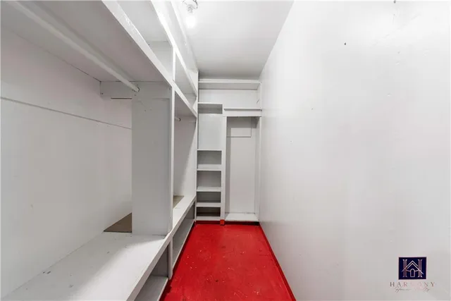 a view of a hallway with wooden floor and closet