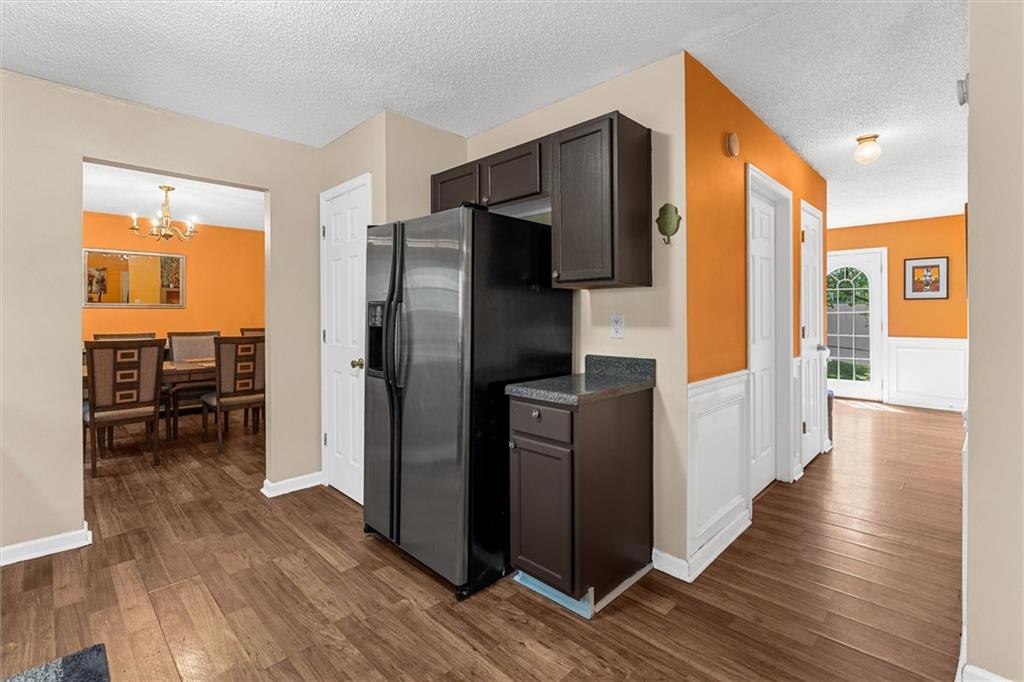 3234 Mineral Ridge Lane Stone Mountain, GA 30087 - Photo 12 of 55 a kitchen with stainless steel appliances a refrigerator and wooden floor