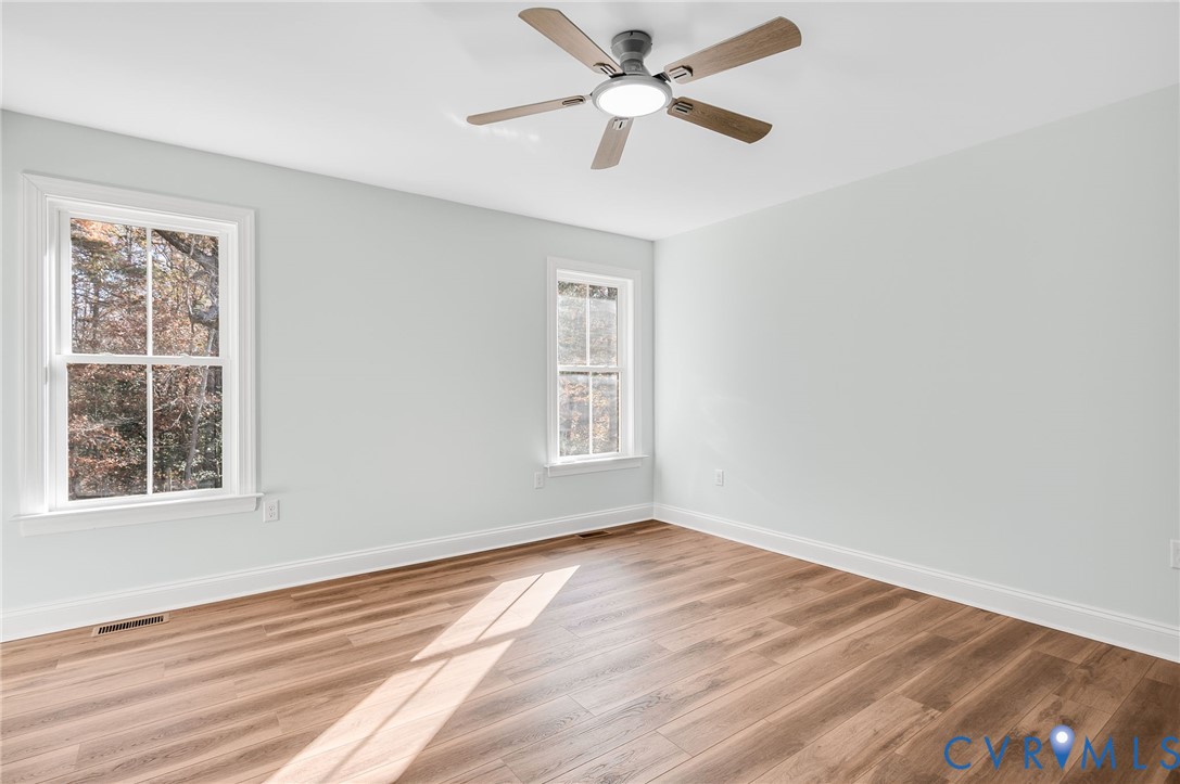 2321 Rock Island Road Scottsville, VA 24590 - Photo 17 of 24 a view of an empty room with wooden floor and a window