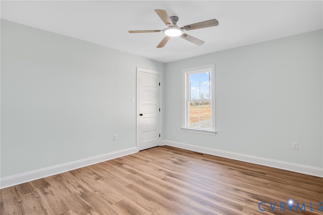 2321 Rock Island Road Scottsville, VA 24590 - Photo 20 of 24 an empty room with wooden floor and windows