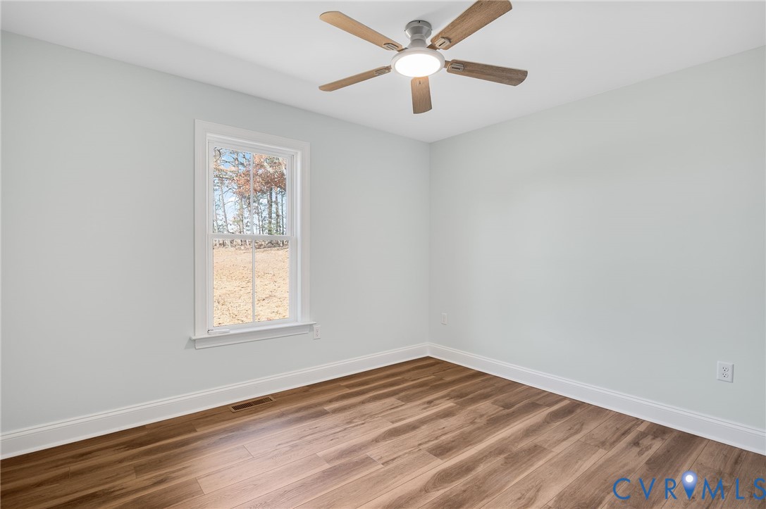 2321 Rock Island Road Scottsville, VA 24590 - Photo 22 of 24 an empty room with wooden floor and windows