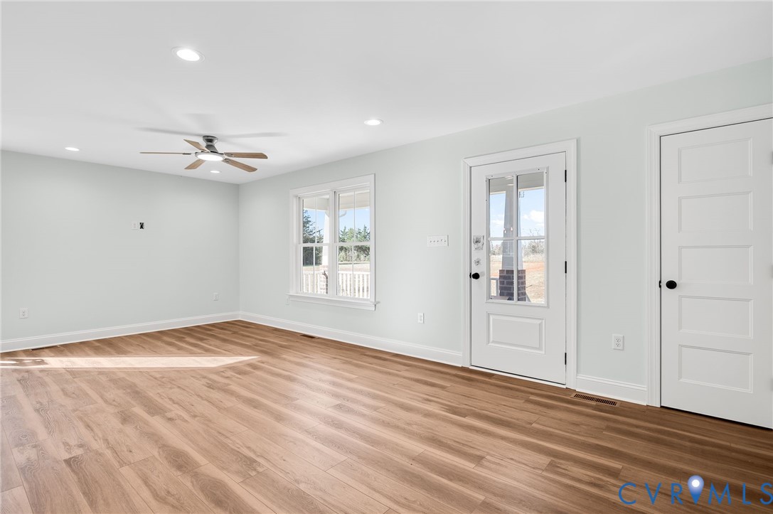 2321 Rock Island Road Scottsville, VA 24590 - Photo 7 of 24 a view of an empty room with wooden floor and a window