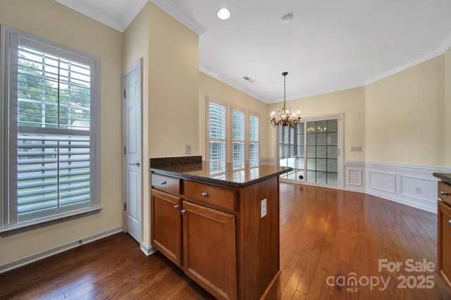 a kitchen with stainless steel appliances granite countertop a stove and a wooden floors