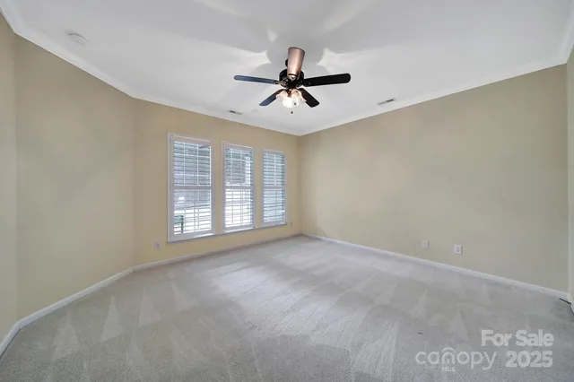 a view of a livingroom with a ceiling fan and window