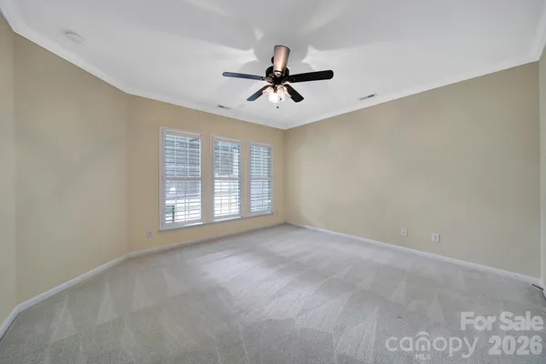 a view of a livingroom with a ceiling fan and window