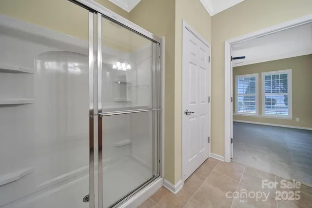 a bathroom with a glass shower door