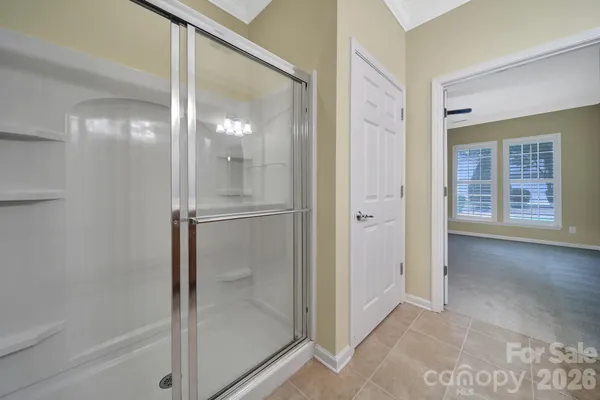 a bathroom with a glass shower door