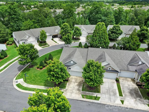 an aerial view of a house with garden space and street view