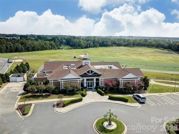 an aerial view of a house with swimming pool and green space