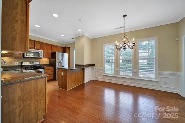 a view of kitchen with sink refrigerator and window