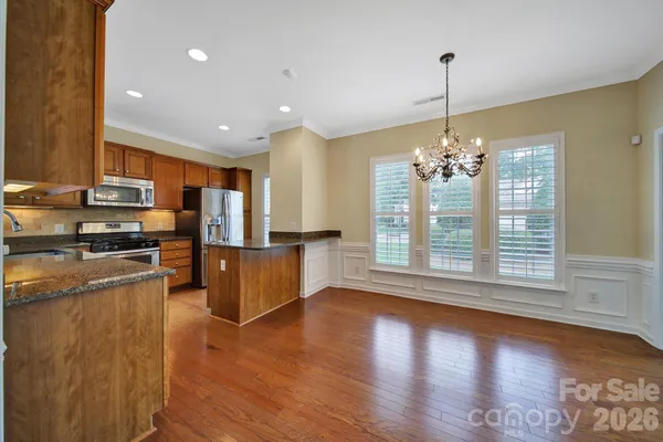 a view of kitchen with sink refrigerator and window